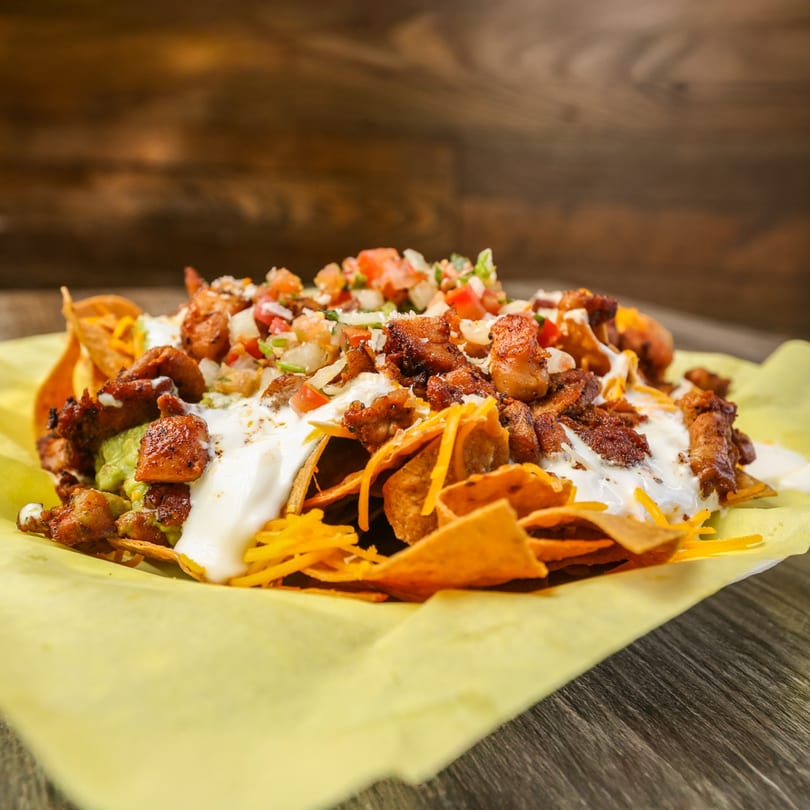 Roberto's Taco Shop nachos with chicken, guacamole, sour cream, cheese, and pico de gallo.