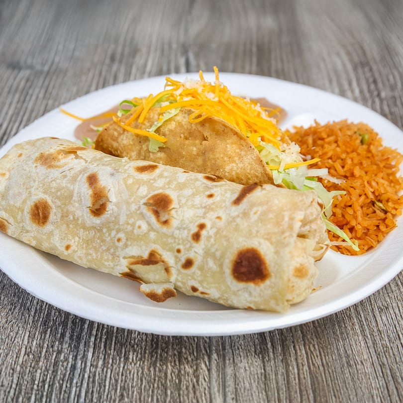 A Roberto's Taco Shop combo plate with a burrito, crispy taco, refried beans, and Mexican rice.